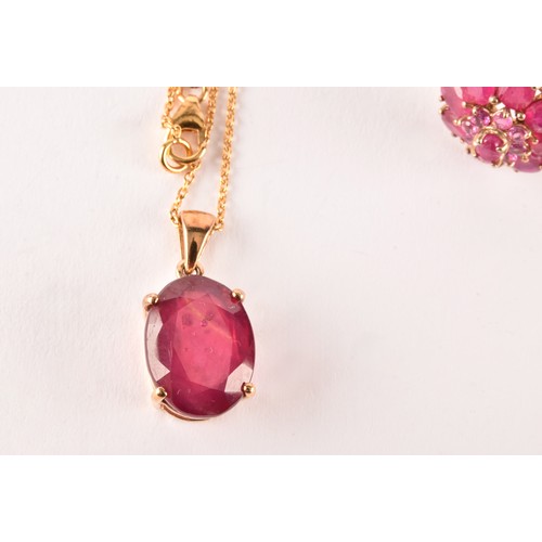 126 - A 10k yellow gold and ruby pendant, set with a mixed oval-cut ruby, four-claw set, suspended on a si... 