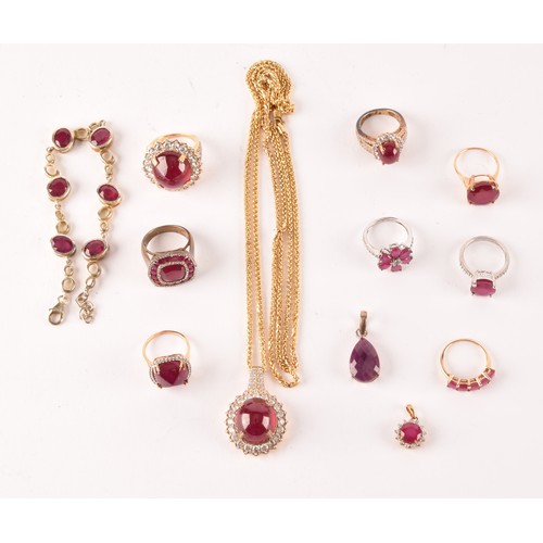 127 - A silver gilt, ruby, and white topaz cluster cocktail ring set with a large cabochon ruby (glass-fil... 