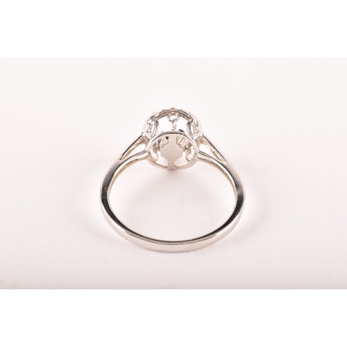 131 - A 14ct white gold and diamond ring, the halo mount set with white diamonds, and centred with a 'floa... 