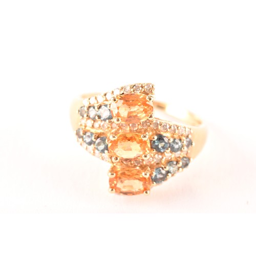 135 - A 14ct yellow gold, citrine, sapphire, and diamond crossover ring, set with three mixed oval-cut cit... 