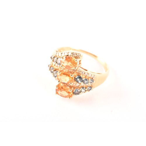 135 - A 14ct yellow gold, citrine, sapphire, and diamond crossover ring, set with three mixed oval-cut cit... 