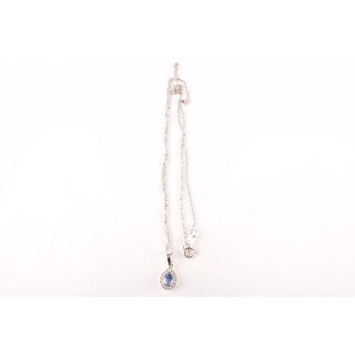 136 - An 18ct white gold, diamond and blue sapphire pendant, set with a mixed pear-cut sapphire within a b... 