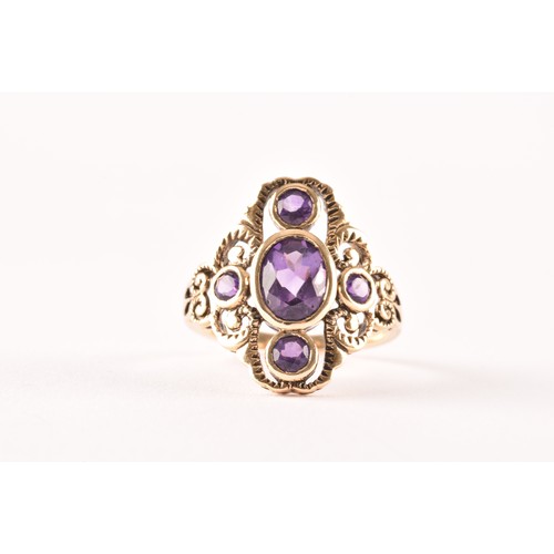 139 - A 9ct yellow gold and amethyst ring, collet set with mixed oval-cut and round-cut amethysts, the sty... 