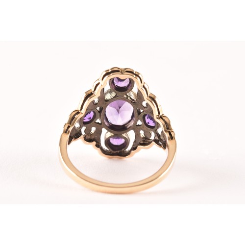 139 - A 9ct yellow gold and amethyst ring, collet set with mixed oval-cut and round-cut amethysts, the sty... 