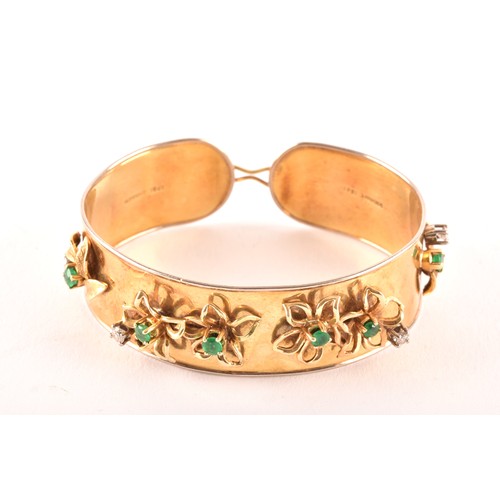 An 18ct yellow gold bangle, set with eight round emeralds with an approximate combined weight of 0.80 carats, interspersed by five round brilliant cut diamonds with an approximate combined weight of 0.50 carats, marked 'Schwartz', 38.6 grams.