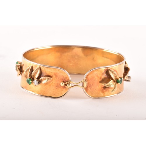 149 - An 18ct yellow gold bangle, set with eight round emeralds with an approximate combined weight of 0.8... 