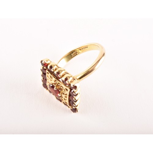 152 - A 9ct yellow gold marquise shape cluster ring set to centre with an oval garnet surrounded by sixtee... 