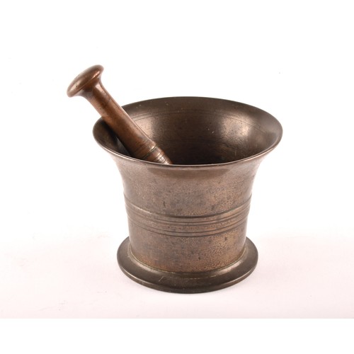 251 - A 19th century bronze pestle and mortar, with engraved lined decoration and relief detail to waist, ... 