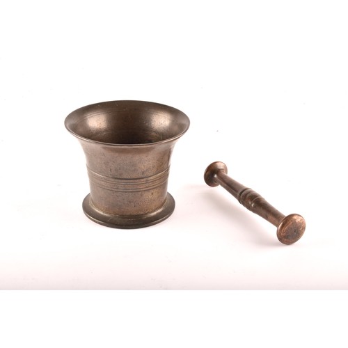 251 - A 19th century bronze pestle and mortar, with engraved lined decoration and relief detail to waist, ... 