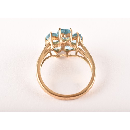 155 - A 9ct yellow gold and blue topaz floral cluster ring, set with five mixed heart-cut topaz, flowerhea... 