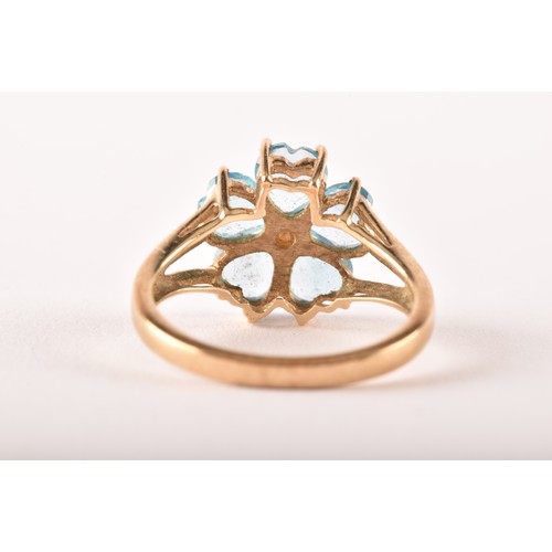 155 - A 9ct yellow gold and blue topaz floral cluster ring, set with five mixed heart-cut topaz, flowerhea... 