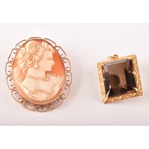 159 - A 9ct yellow gold mounted cameo brooch, depicting a finely dressed lady, within an openwork millegra... 