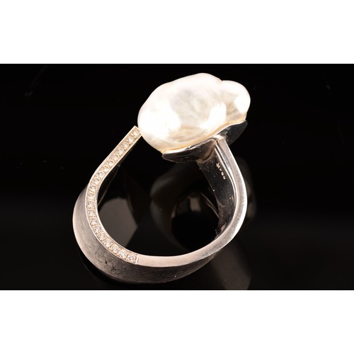 96 - A 18ct white gold ring, featuring a baroque pearl measuring approximately 1.8 x 2cm, further adorned... 