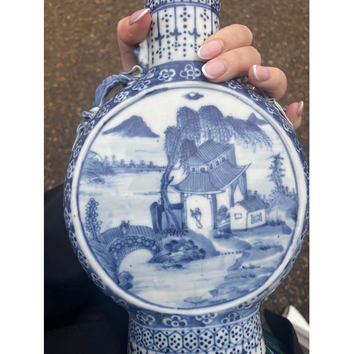 5 - A Chinese blue and white moon flask, with twin dragon handles, the body painted with a scene of figu... 