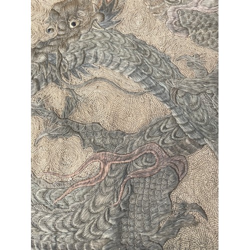 19 - A large antique Chinese silk needlework tapestry wall hanging, decorated with give dragons chasing a... 