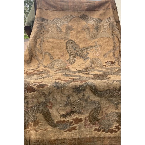 19 - A large antique Chinese silk needlework tapestry wall hanging, decorated with give dragons chasing a... 