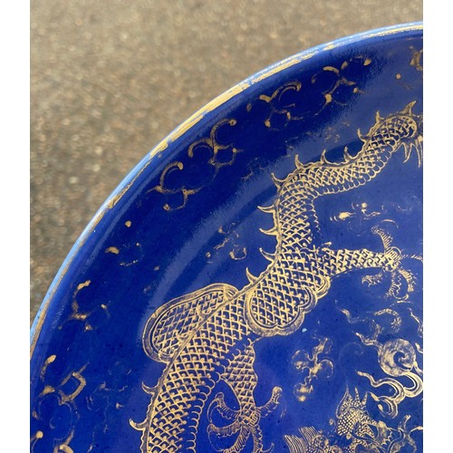 13 - A Chinese Qing Dynasty blue glaze and gilt porcelain dragon pattern dish, a pair of dragons with the... 