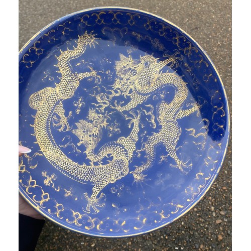 13 - A Chinese Qing Dynasty blue glaze and gilt porcelain dragon pattern dish, a pair of dragons with the... 