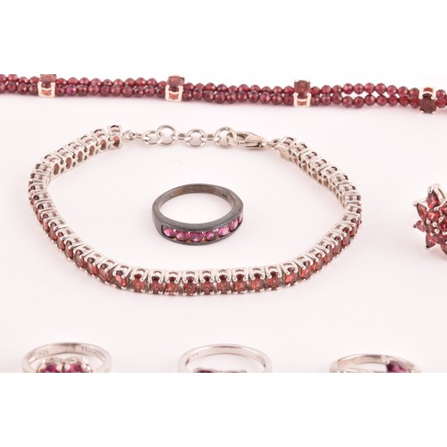 48 - A group of ten various silver and garnet rings, set with pyrope and almandine garnets, various desig... 