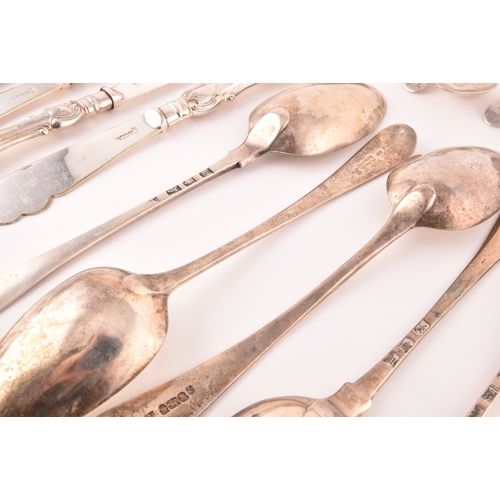 111 - A collection of Georgian and Victorian silver cutlery, to include an array of spoons, knives, a tea ... 