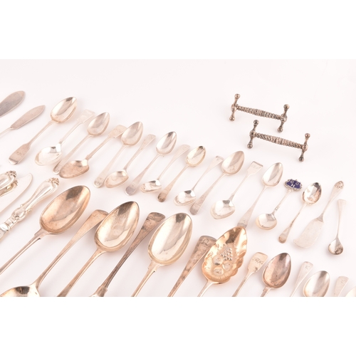 111 - A collection of Georgian and Victorian silver cutlery, to include an array of spoons, knives, a tea ... 