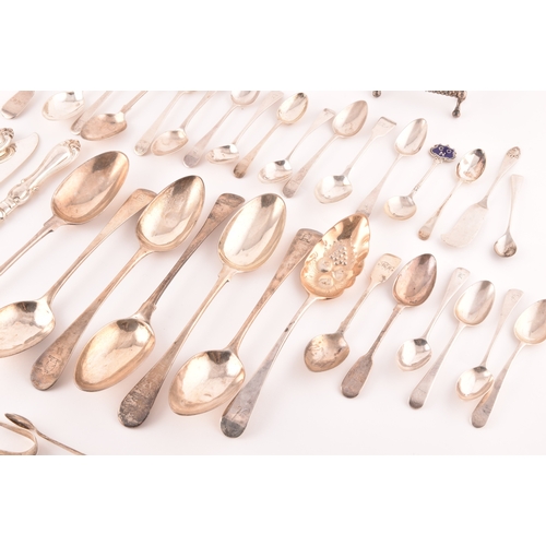 111 - A collection of Georgian and Victorian silver cutlery, to include an array of spoons, knives, a tea ... 