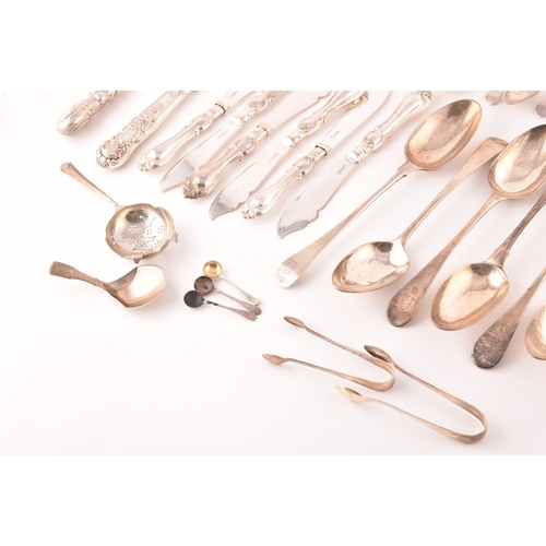 111 - A collection of Georgian and Victorian silver cutlery, to include an array of spoons, knives, a tea ... 