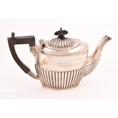 112 - An Edward VII silver bachelors three piece tea set, all half gadrooned, teapot with ebonised knop an... 