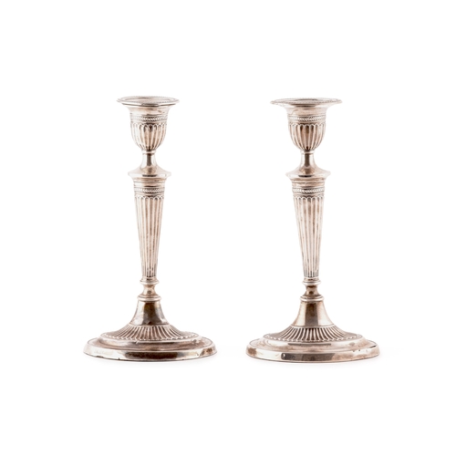 114 - A pair of George V silver candlesticks, hallmarked for 1930 by Fordham & Faulkner,Robert Adam de... 