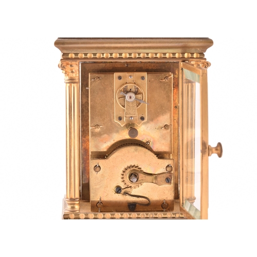 273 - A late 19th/early 20th century ormolu carriage clock, white enamel dial with subsidiary seconds dial... 