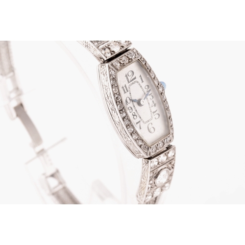 91 - A vintage 9ct white gold and diamond cocktail watch, the silvered numbered dial with tapered blue in... 