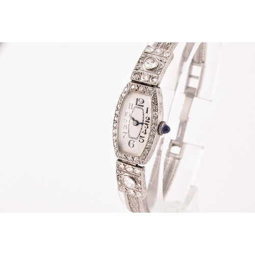 91 - A vintage 9ct white gold and diamond cocktail watch, the silvered numbered dial with tapered blue in... 