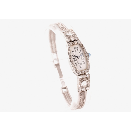 91 - A vintage 9ct white gold and diamond cocktail watch, the silvered numbered dial with tapered blue in... 