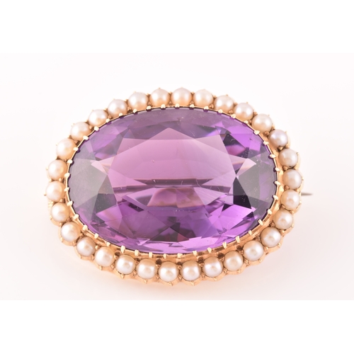 4 - A 10ct yellow gold amethyst and pearl brooch, set to centre with a oval cut amethyst measuring appro... 