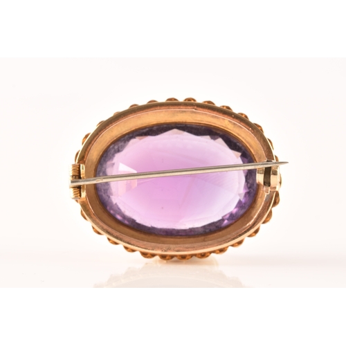 4 - A 10ct yellow gold amethyst and pearl brooch, set to centre with a oval cut amethyst measuring appro... 