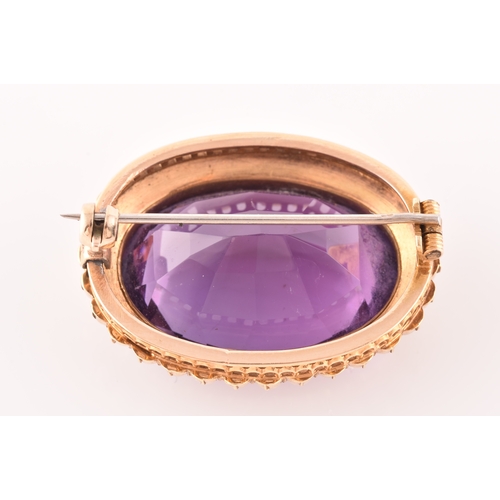 4 - A 10ct yellow gold amethyst and pearl brooch, set to centre with a oval cut amethyst measuring appro... 