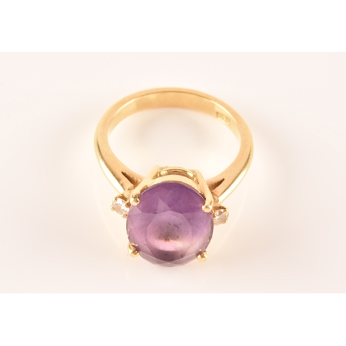 10 - A 18ct yellow gold amethyst and diamond flanked solitaire, set with an oval cut amethyst with a appr... 