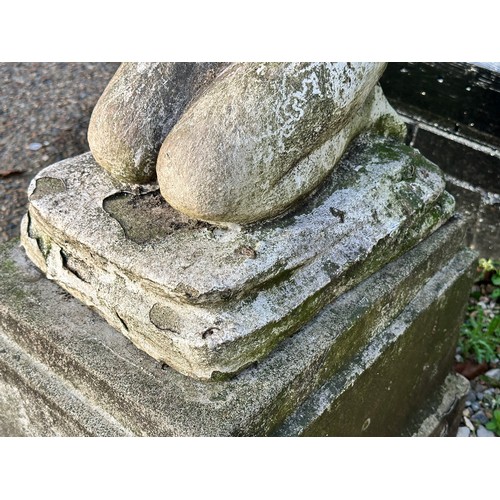 205 - An early 20th century carved and painted stone bird bath, modelled as a nude girl holding aloft a di... 