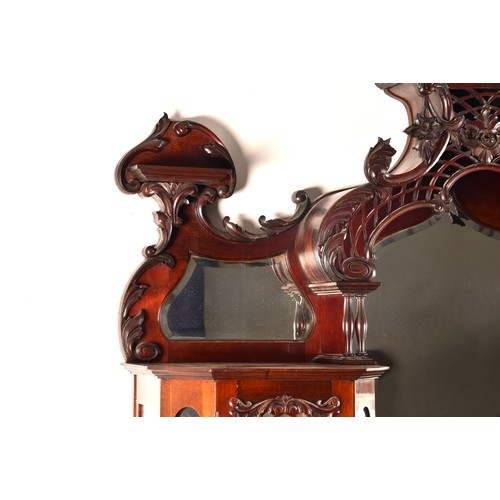 283 - A 19th century carved mahogany display cabinet, the mirrored back with elaborate carved and scrolled... 