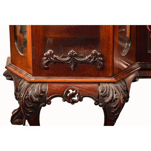 283 - A 19th century carved mahogany display cabinet, the mirrored back with elaborate carved and scrolled... 