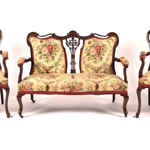 288 - An Edwardian carved mahogany salon suite, comprising a settee, two arm chairs, and four single chair... 