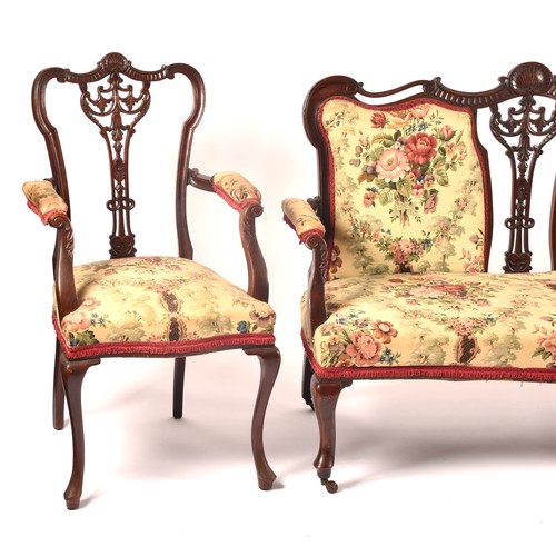 288 - An Edwardian carved mahogany salon suite, comprising a settee, two arm chairs, and four single chair... 