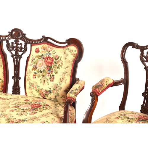 288 - An Edwardian carved mahogany salon suite, comprising a settee, two arm chairs, and four single chair... 