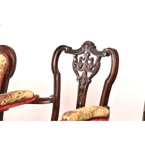 288 - An Edwardian carved mahogany salon suite, comprising a settee, two arm chairs, and four single chair... 