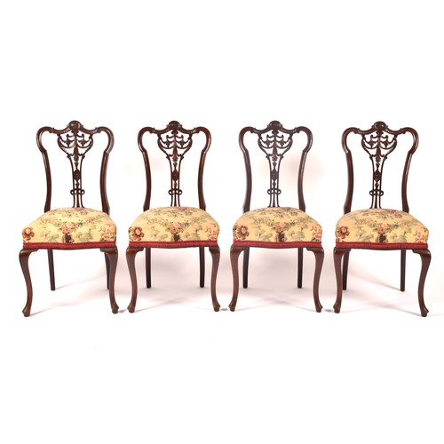 288 - An Edwardian carved mahogany salon suite, comprising a settee, two arm chairs, and four single chair... 