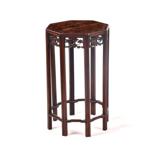 214 - A 19th century Chinese carved hardwood side table, with plain octagonal top and carved foliate friez... 