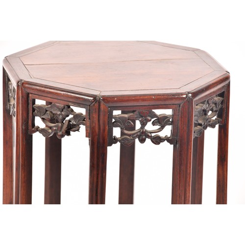 214 - A 19th century Chinese carved hardwood side table, with plain octagonal top and carved foliate friez... 