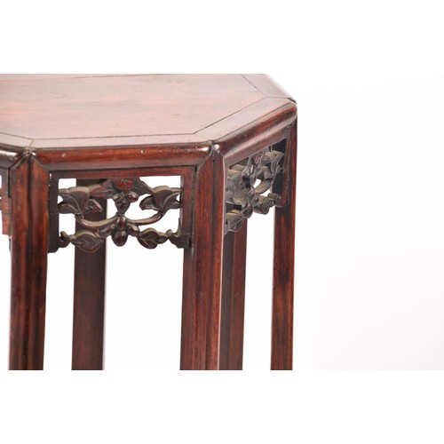 214 - A 19th century Chinese carved hardwood side table, with plain octagonal top and carved foliate friez... 