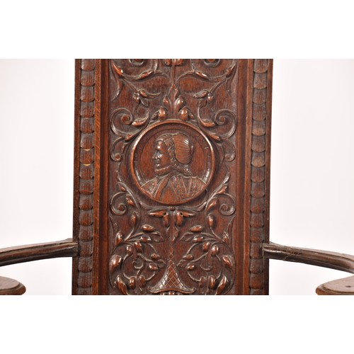 291 - An 19th century carved oak armchair, the back carved with the bust of the green man, above a panel c... 