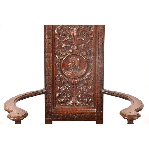 291 - An 19th century carved oak armchair, the back carved with the bust of the green man, above a panel c... 